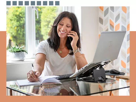 A lady on the telephone in a home office