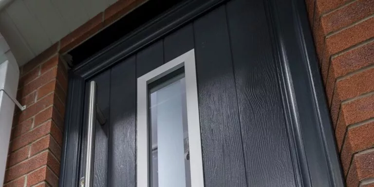 Anthracite grey solid core door with a vertical glazed panel