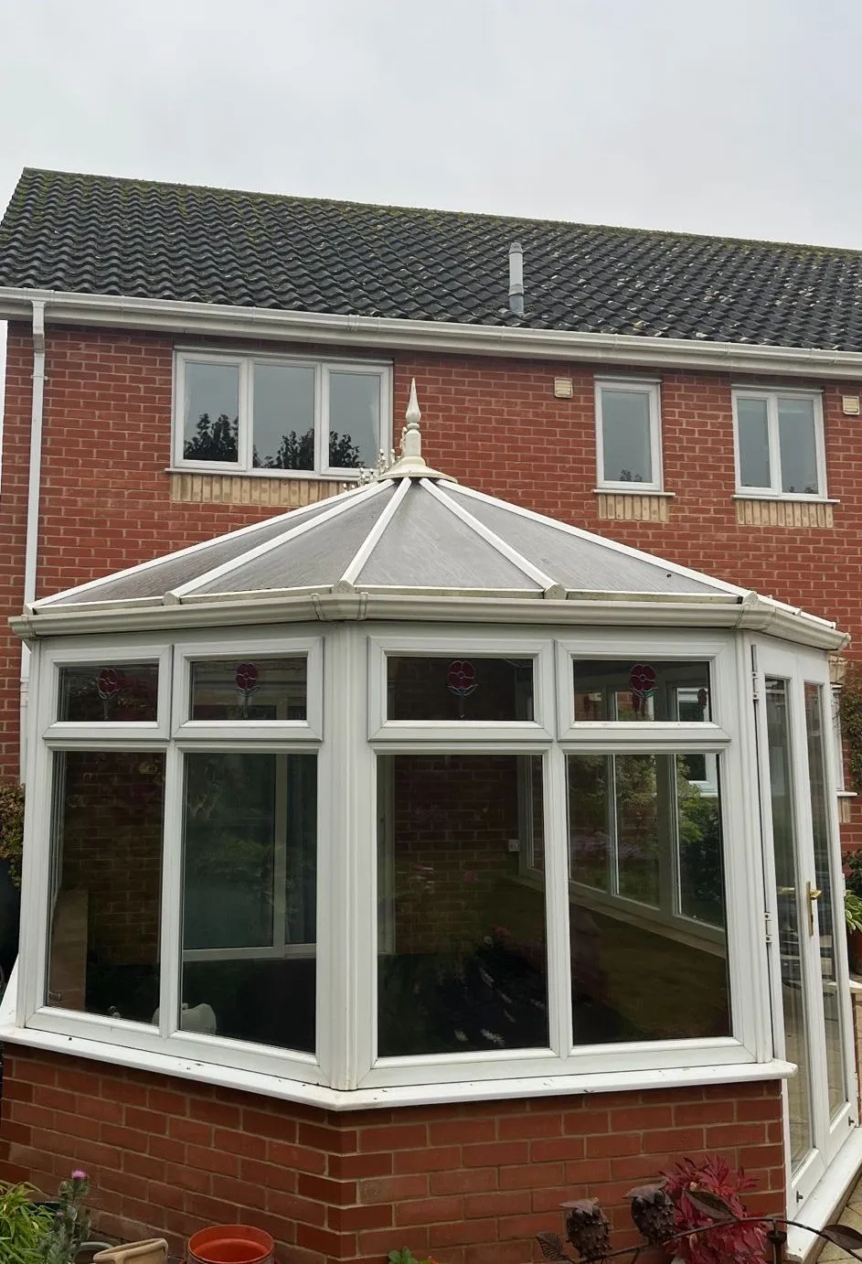 Old polycarbonate-roof conservatory in Dereham NR20 before roof upgrade.