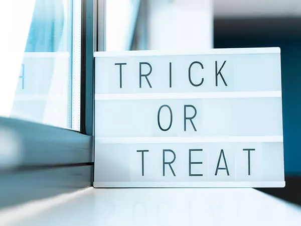 Trick or treat written on a light box