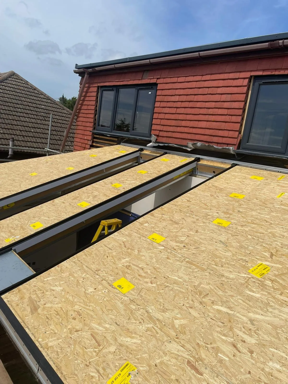 Timber roof deck fixed over the rafters of a new living space roof