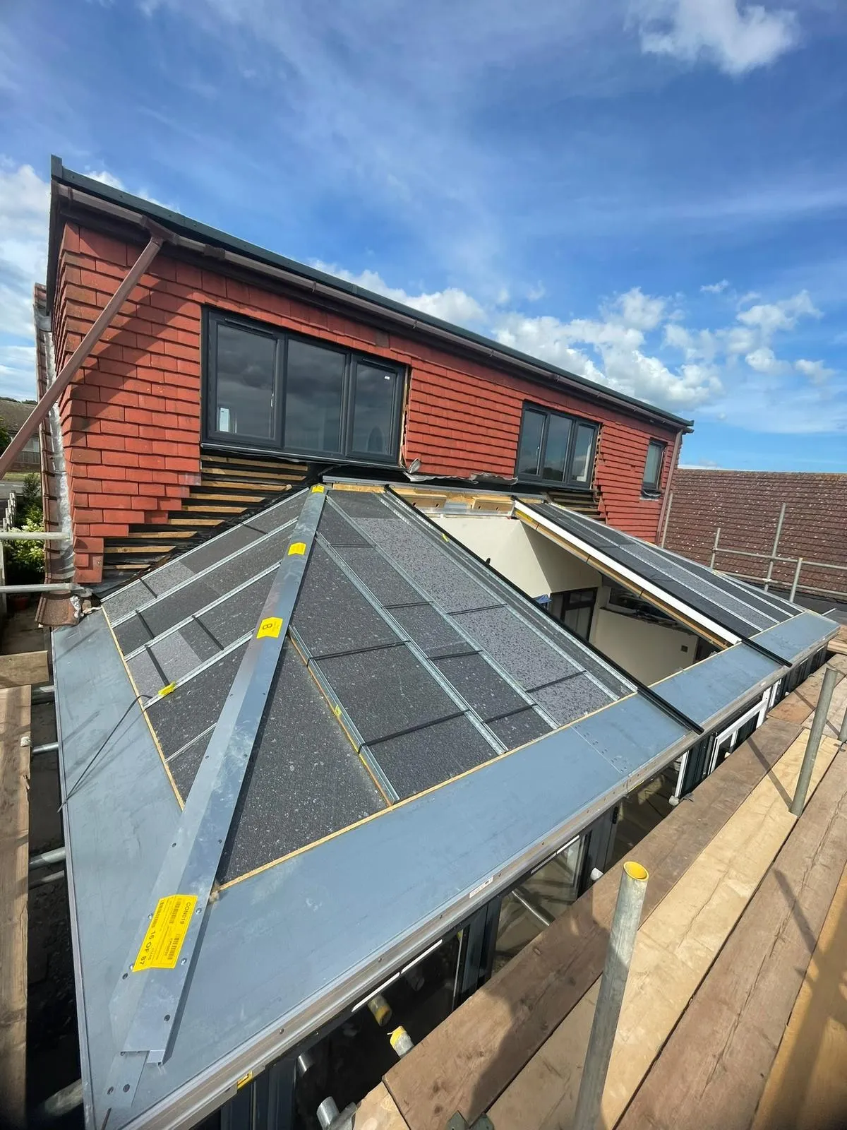 New solid roof frame over the living space with new anthracite grey dormer windows above