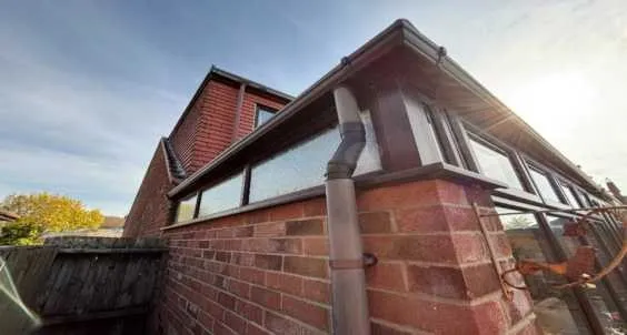 Existing brick dwarf wall and old conservatory frames before rebuild