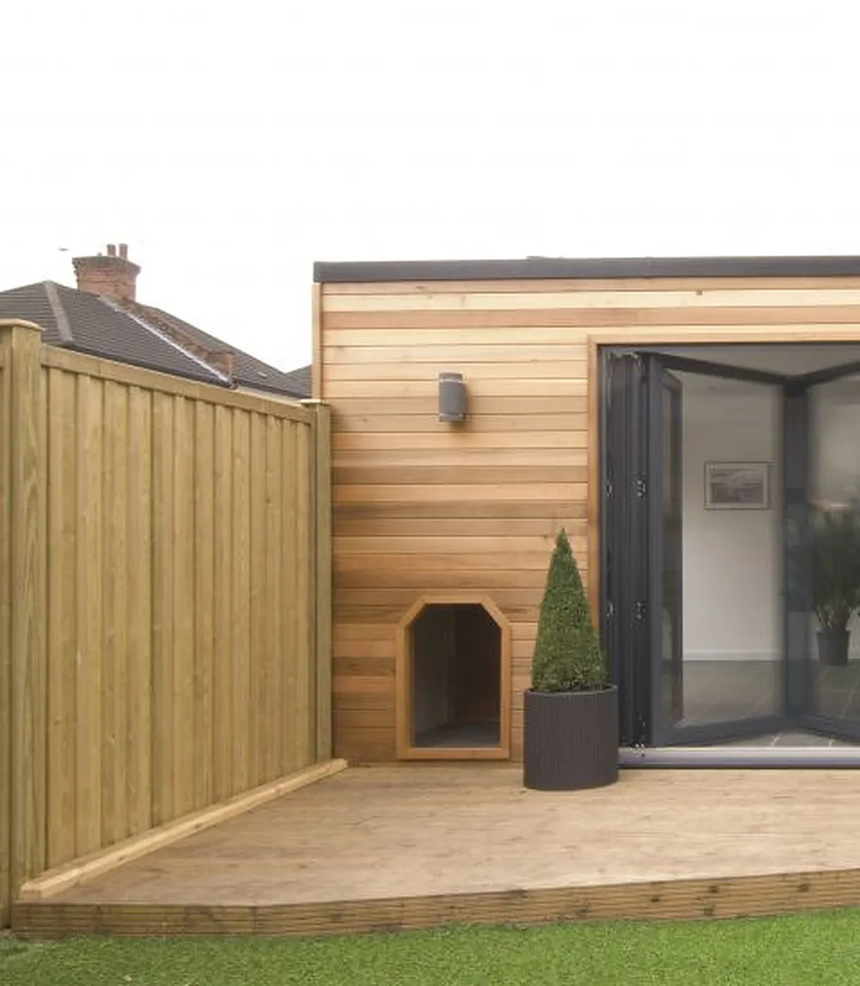 Light timber cladding and anthracite bi-fold doors on a garage conversion, Drayton NR8