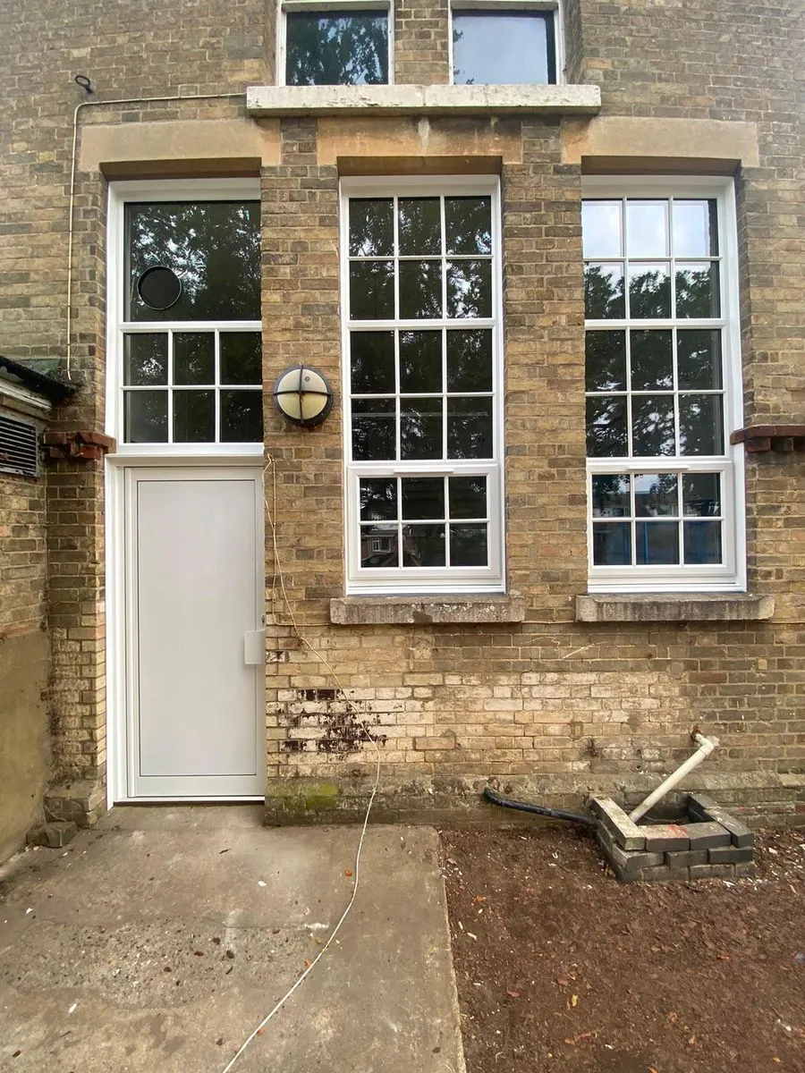New white solid aluminium kitchen door, tall white uPVC windows, attic windows and extractor fan at Horsford CofE VA Primary School