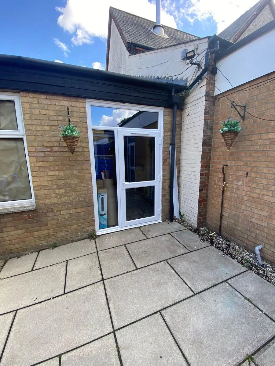 New white door with side panel, glazed top light and overhead closer at Horsford CofE VA Primary School