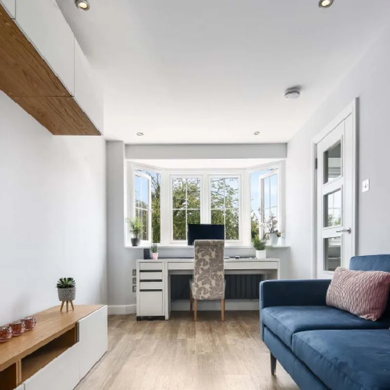 Garage conversion home office with white bay casements and visible trickle vents, Norfolk