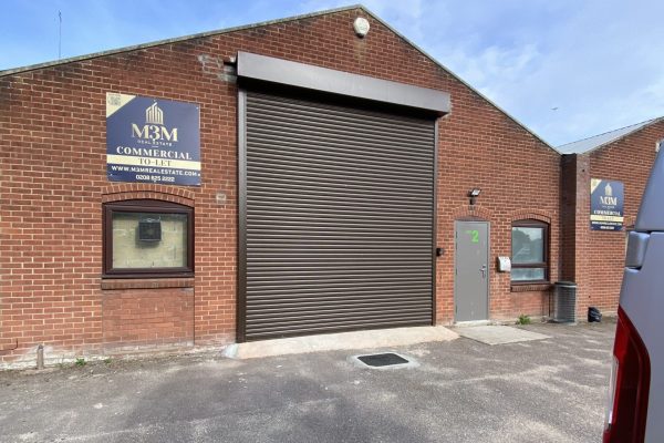 Original roller shutter frontage at Trebles Darts unit in North Walsham, prior to shopfront installation.