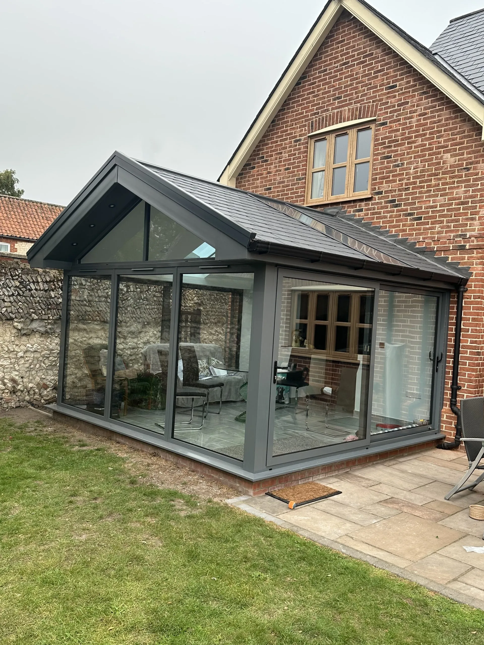 Completed modern conservatory with anthracite grey frames and Guardian Warm Roof in NR13, installed by Amber Home Improvements