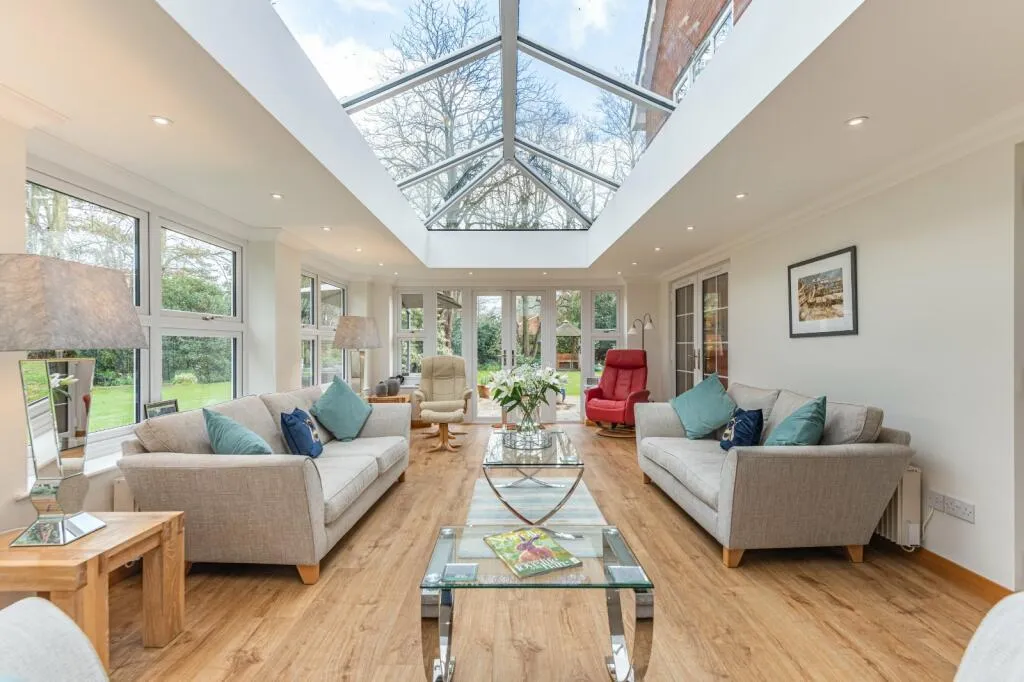 Orangery living room with a large central roof lantern and French doors
