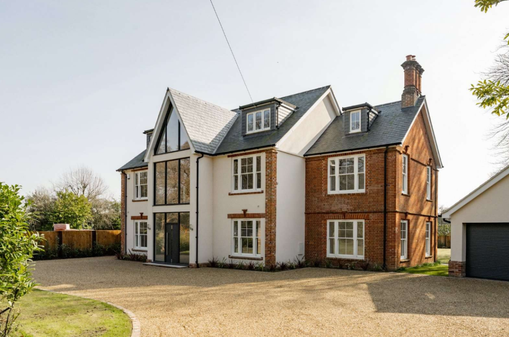 White woodgrain uPVC sliding sash windows on Victorian home in Poringland