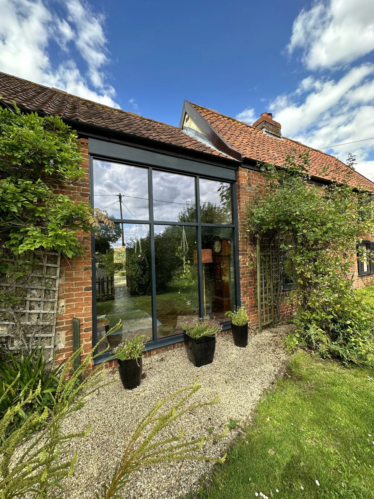 Floor-to-ceiling anthracite aluminium curtain walling onto the garden, Welborne NR20 Norfolk