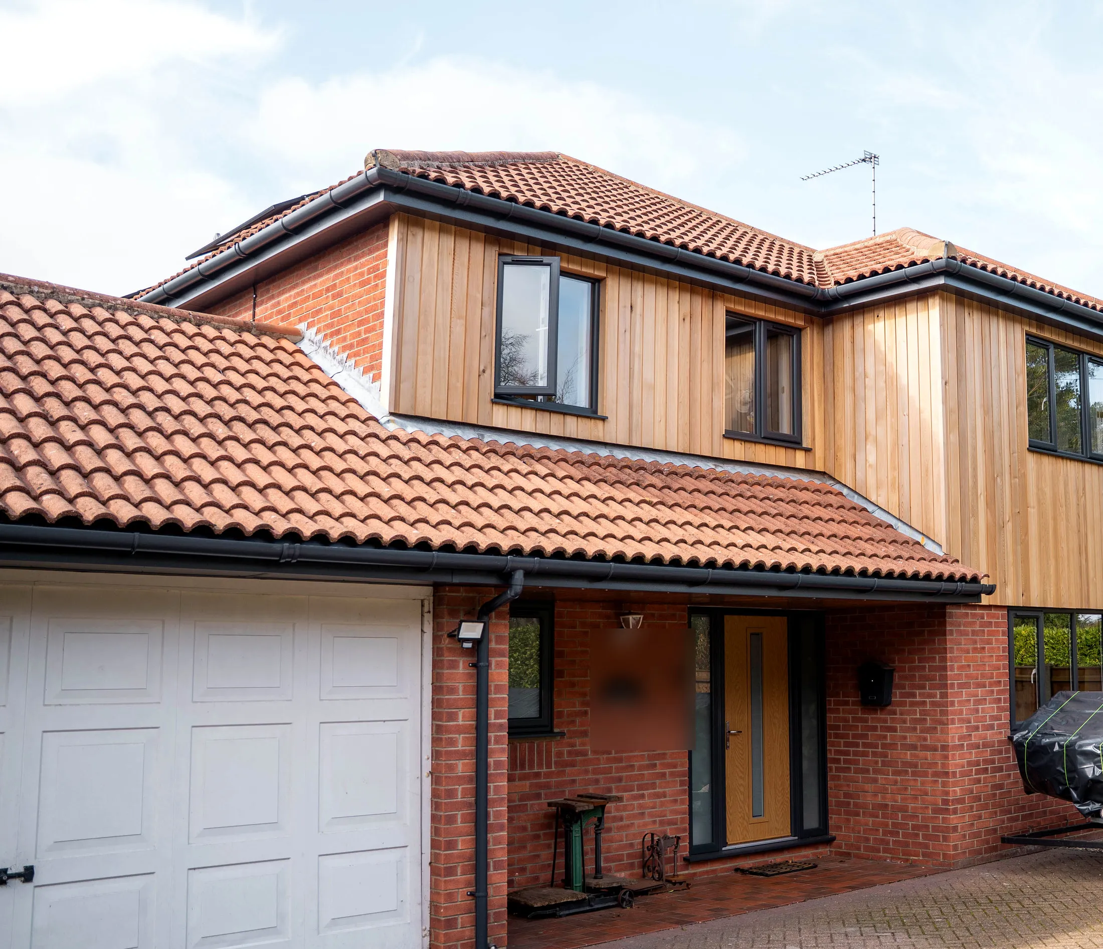 Vertical red cedar cladding on the first floor of a St Olaves NR31 home