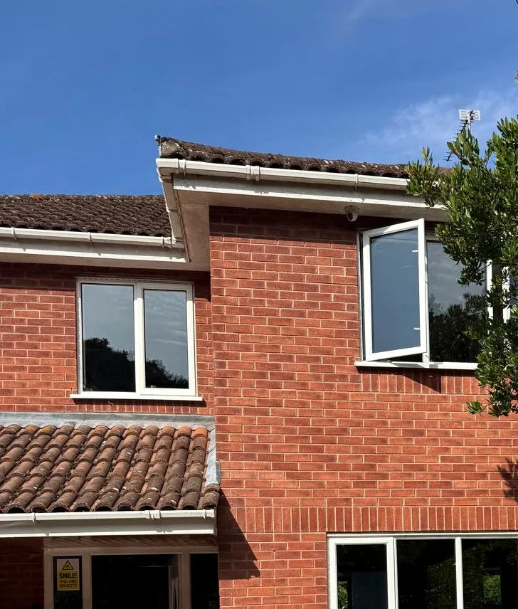 Red brick first floor and white windows before cladding, St Olaves NR31
