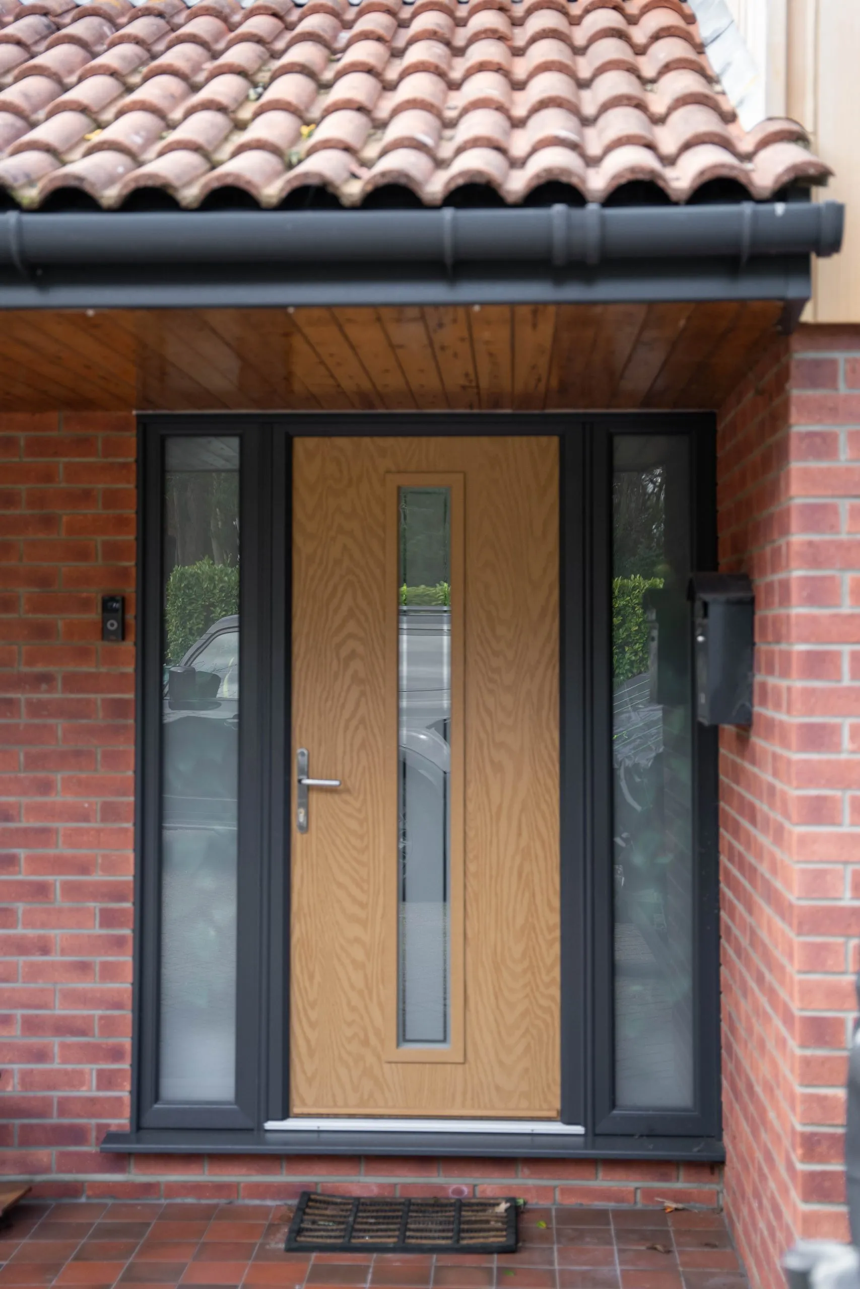 After: light oak composite front door in an anthracite frame with frosted sidelights, St Olaves NR31