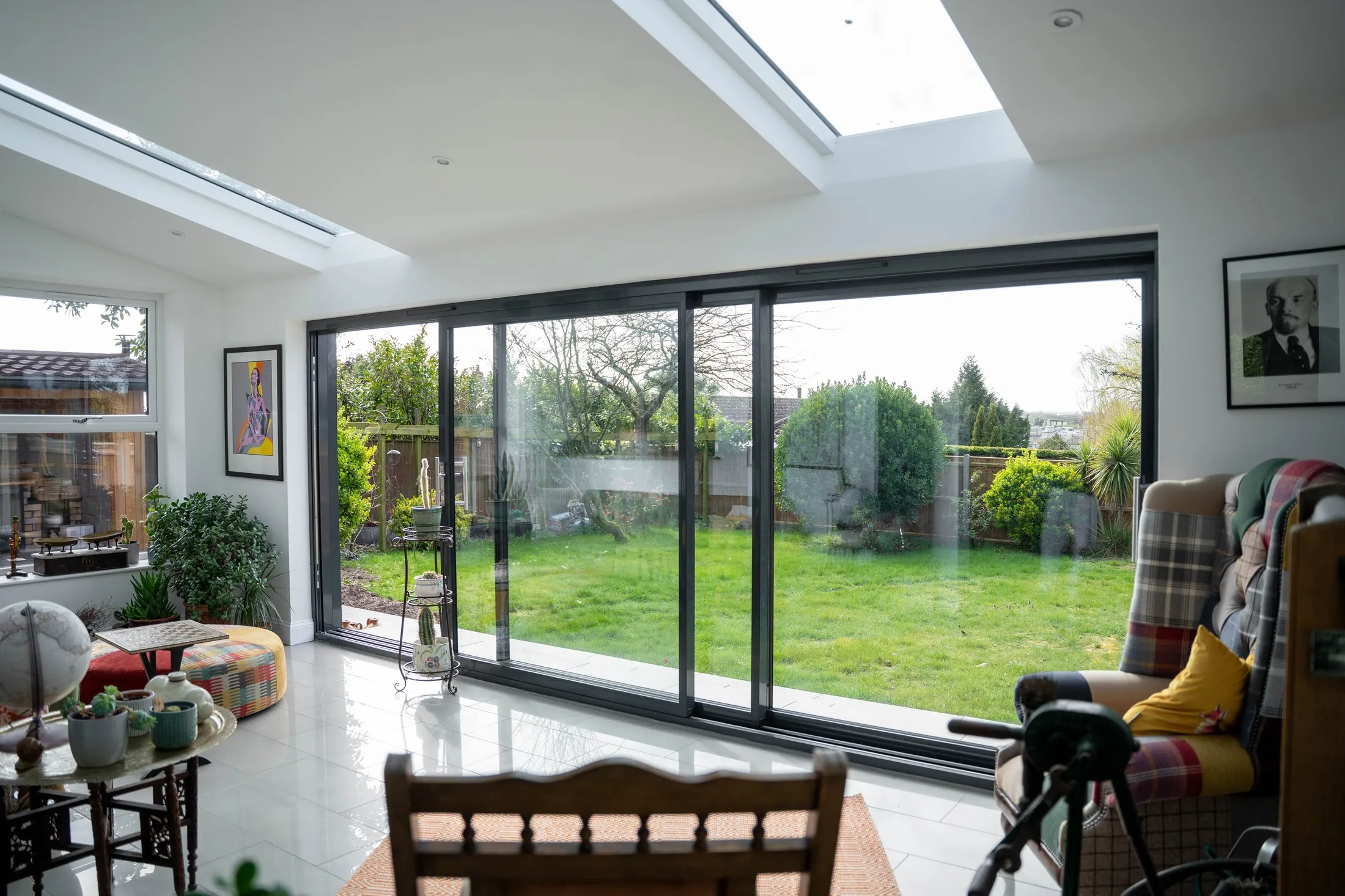 Inside the St Olaves NR31 rear extension, looking out through anthracite sliding doors under two rectangular skylights
