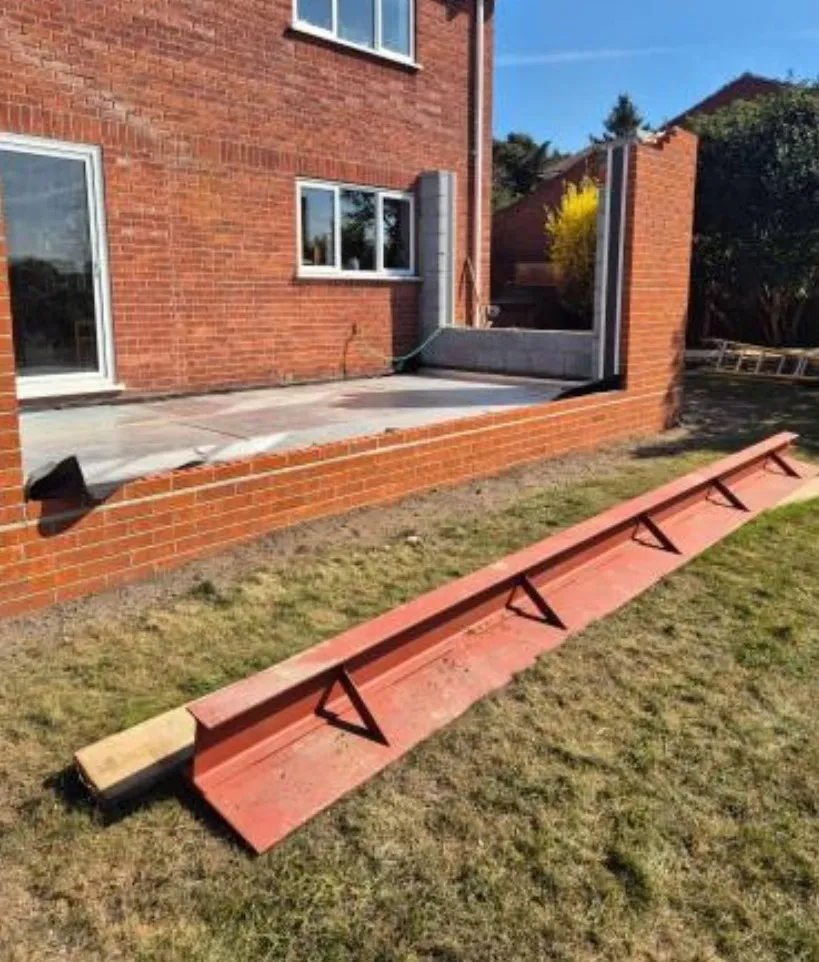 Red-oxide steel RSJ on the lawn during structural reinforcing of the St Olaves NR31 rear extension