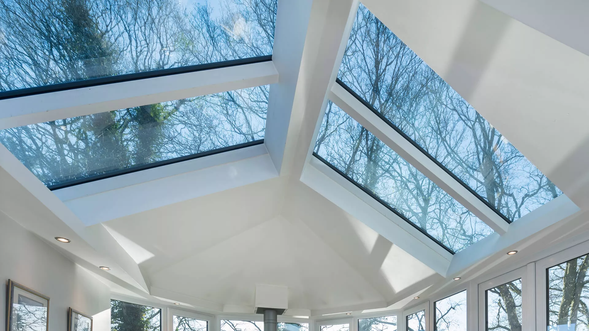 Inside a conservatory with a white plastered tiled roof and glazed roof panels