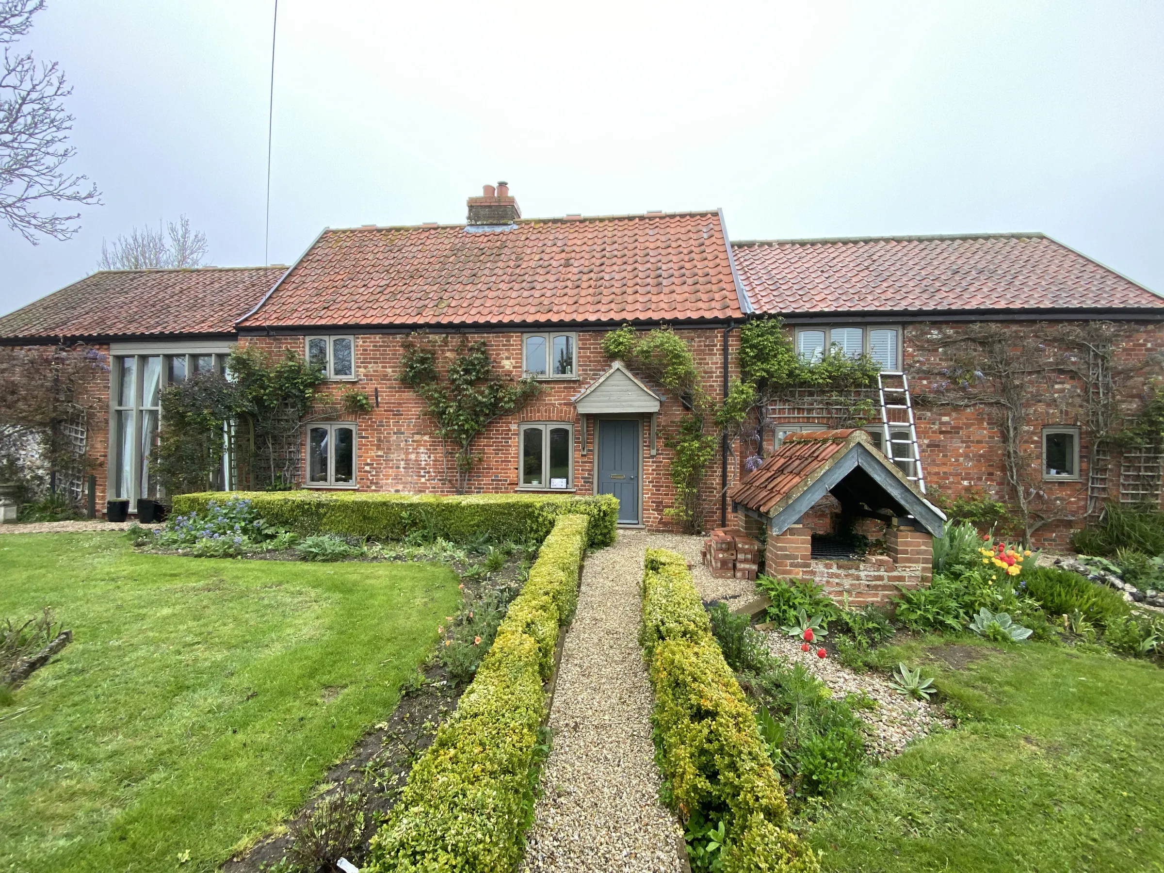 Before: painted sage-green casements and older tall glazed bay on the front elevation, Welborne NR20