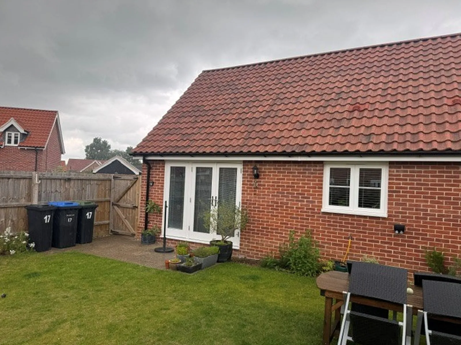 Before: red-brick rear elevation with white French doors, sidelights and casement window, Woodbridge IP13