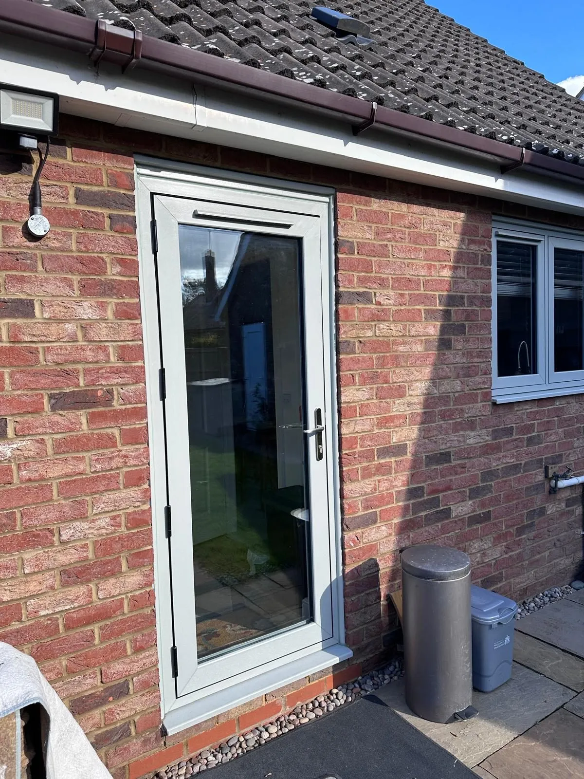 Fully glazed agate grey flush utility door with black hinges, in the Downham Market area